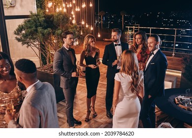 Group of people in formalwear communicating and smiling while spending time on luxury party - Shutterstock ID 2039784620