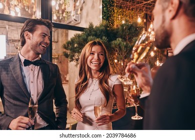 Group of people in formalwear communicating and smiling while spending time on luxury party - Shutterstock ID 2039784686