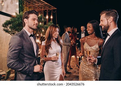 Group Of People In Formalwear Communicating And Smiling While Spending Time On Luxury Party