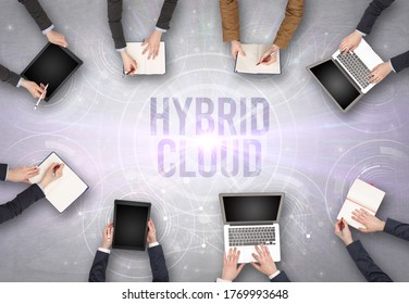 Group Of People In Front Of A Laptop With HYBRID CLOUD Insciption, Web Security Concept