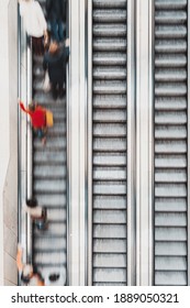 Group Of People Going Up On Escalator