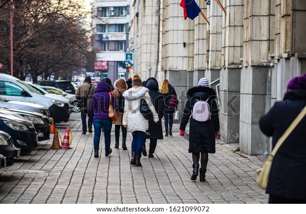 Group of people going to work in the morning in\
Bucharest, Romania, 2020