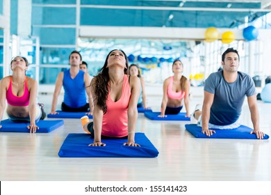 Group of people at the gym in a yoga class 