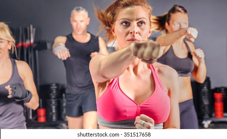 Group Of People In A Hard Boxing Class On Gym Training Punch