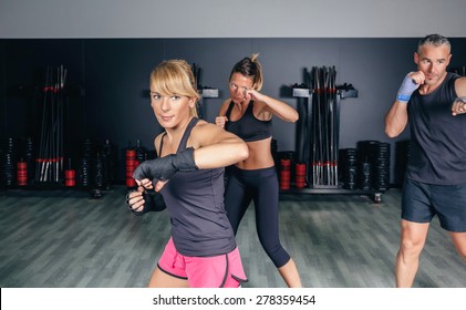 Group Of People In A Hard Boxing Training On Fitness Center