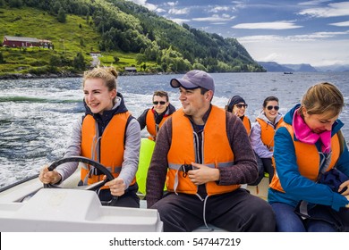 Group Of People Having A Boat Trip Along The Fjord, Norway