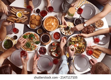 Group of people having brunch together at table indoors, top view - Powered by Shutterstock