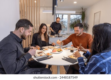 Group of people having dinner with private chef at home  - Powered by Shutterstock