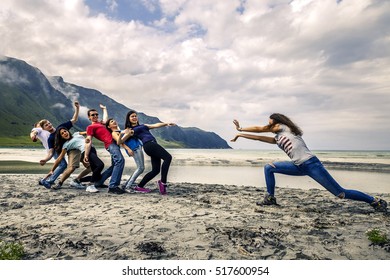 Group Of People Having Fun On The Beach Of Norway