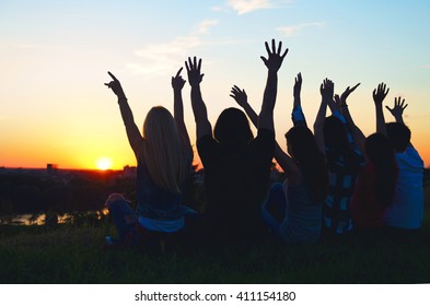Group of people having fun outdoors; sunset 