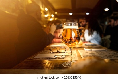 Group Of People Having Lunch At Brewery Bar Restaurant - Close Up Glass Beer On Dining Table - Brewery And Food Concept