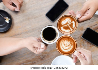 Group of people having a meeting after successful business negotiation in a coffee shop.Drinking hot beverage latte art coffee - Powered by Shutterstock