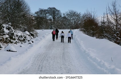 A Group Of People Hiking Up The Mountain Towards The Wind Farm At Glendevon, Perth And Kinross, Scotland, Europe On Wednesday, 10th, February, 2021