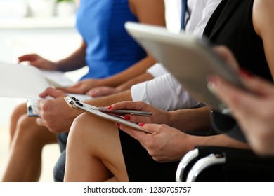 Group of people hold silver pen ready to make note sit in line for an interview waiting. Training course university practice homework school or college exercise secretary table management concept