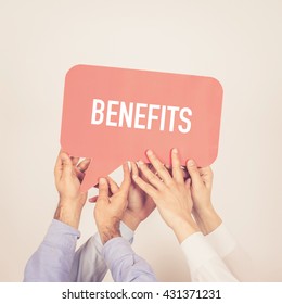 A Group Of People Holding The Benefits Written Speech Bubble