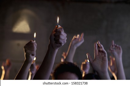 Group Of People Holding Cigarette Lighters At A Concert