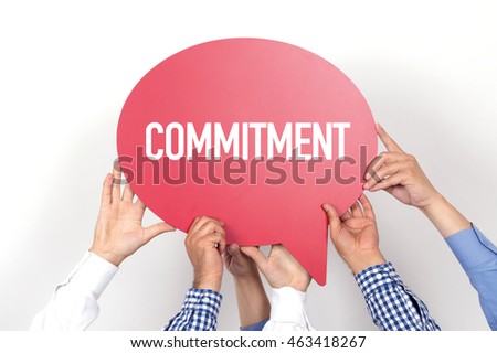 Group of people holding the COMMITMENT written speech bubble