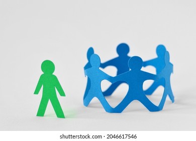 Group of people holding hands in circle and person alone - Concept of social exclusion and isolation