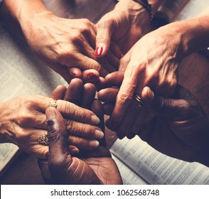 Group of people holding hands praying worship believe - Shutterstock ID 1062568748