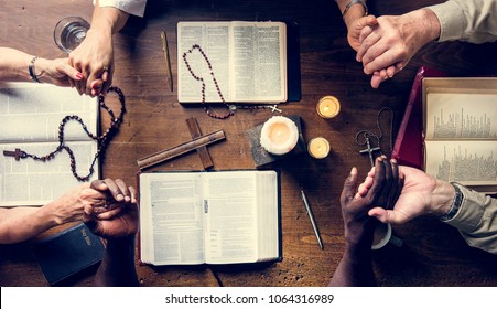 Group of people holding hands praying worship believe - Shutterstock ID 1064316989