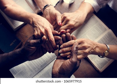 Group of people holding hands praying worship believe - Shutterstock ID 1065977915