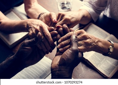 Group of people holding hands praying worship believe - Shutterstock ID 1070293274