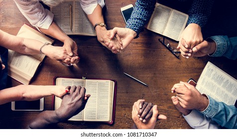 Group of people holding hands praying worship believe - Shutterstock ID 1081710347