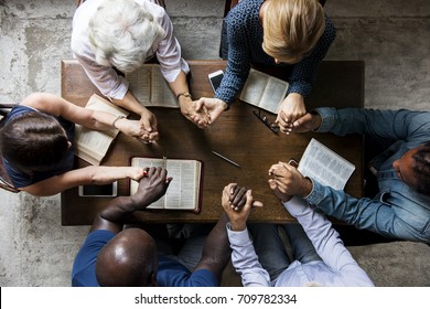 Group of people holding hands praying worship believe - Shutterstock ID 709782334