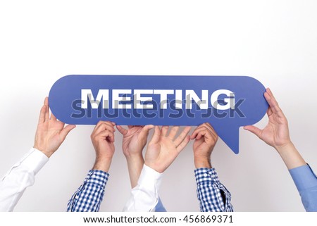 Group of people holding the MEETING written speech bubble