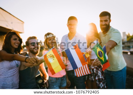 Group of people holding national flags