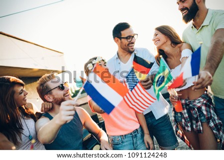 Group of people holding national flags