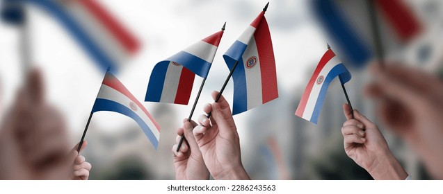 A group of people holding small flags of the Paraguay in their hands. - Shutterstock ID 2286243563