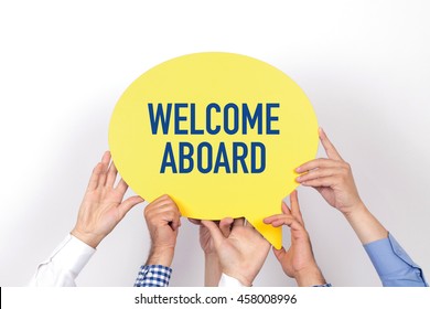 Group of people holding the WELCOME ABOARD written speech bubble