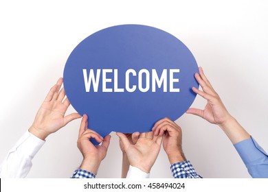 Group Of People Holding The WELCOME Written Speech Bubble