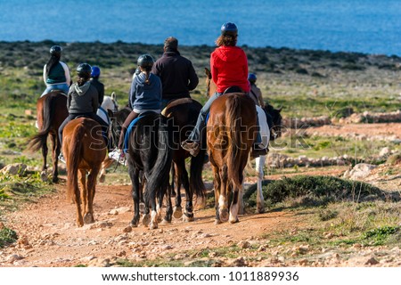A group of people horseriding