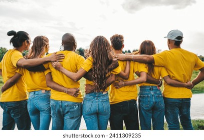 Group of people hugging together - Youth community concept with guys and girls standing outside  - Powered by Shutterstock