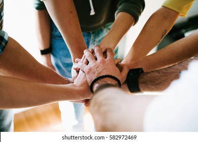 Group Of People Joining Hands Together. College Students Teamwork Stacking Hands.
Young Entrepreneurs Brainstorming On The New Ideas. Teamwork Unity And Solidarity. Business Cooperation.
