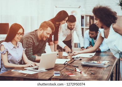 Group Of People. Laptop. Pen. Notepad. Project. Teamwork. Working Desks. Large Bright Office. Cooperation. Different Nationalities. Spend Brainstorming. Work. Table. Color Samples. Design.