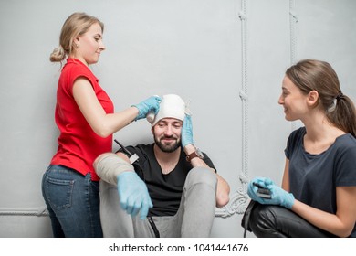 A Group Of People Learning To Apply Bandage To Prevent Bleeding During The First Aid Training Indoors