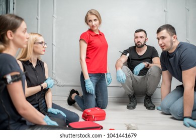 A Group Of People Learning To Apply The Tourniquet To Prevent Bleeding During The First Aid Training Indoors