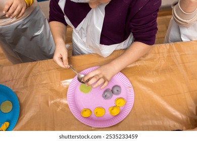 Group of people making homemade dumplings or ravioli together. Hands shaping dough and filling on a wooden board. Cooking class or family bonding through traditional food preparation - Powered by Shutterstock