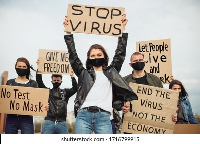 A group of people with mask and posters to protest The protest of the population against coronavirus and against the introduction of quarantine Meeting about coronavirus and people rights. copyspace