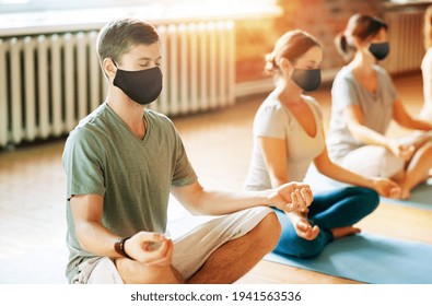 Group Of People In Masks Doing Yoga At Studio