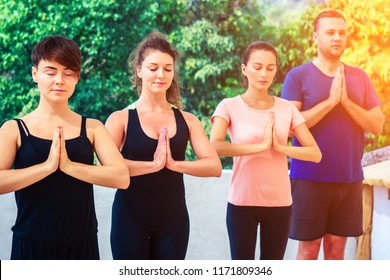 a group of people meditate in a yoga class