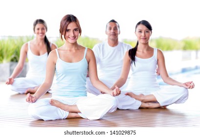 Group of people meditating in a yoga studio - Powered by Shutterstock