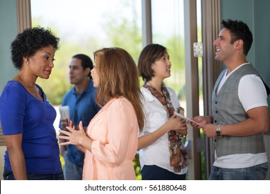 A group of people networking in a lobby.