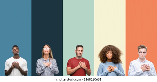 Group of people over vintage colors background smiling with hands on chest with closed eyes and grateful gesture on face. Health concept. - Shutterstock ID 1168120681