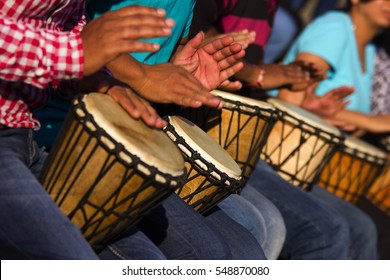 Group of people playing African drums, Djembe,