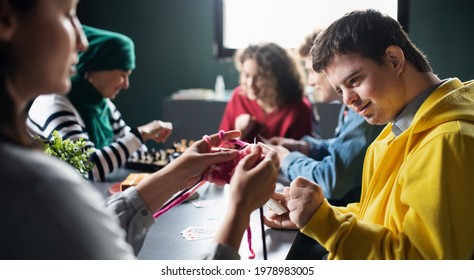 Group of people playing cards and board games in community center, inclusivity of disabled person. - Shutterstock ID 1978983005