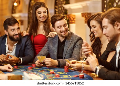 A Group Of People Playing Gambling In A Casino